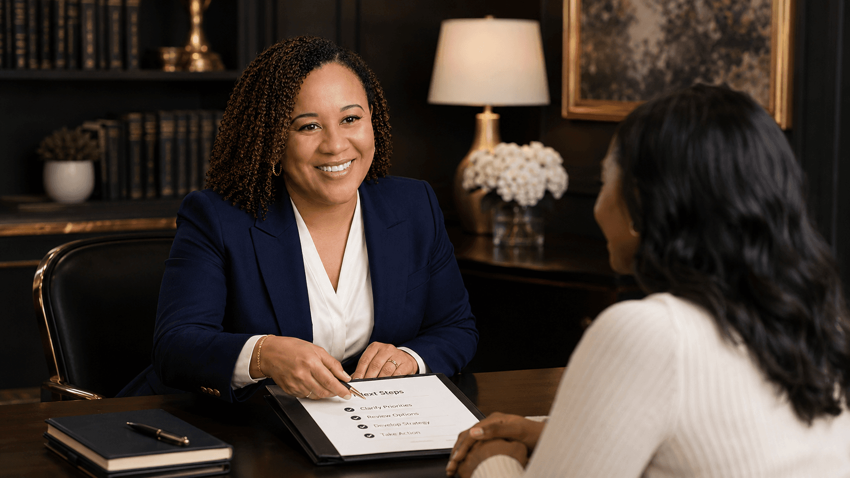 Smiling professional woman in a blue blazer reviews a "Next Steps" document with a client.